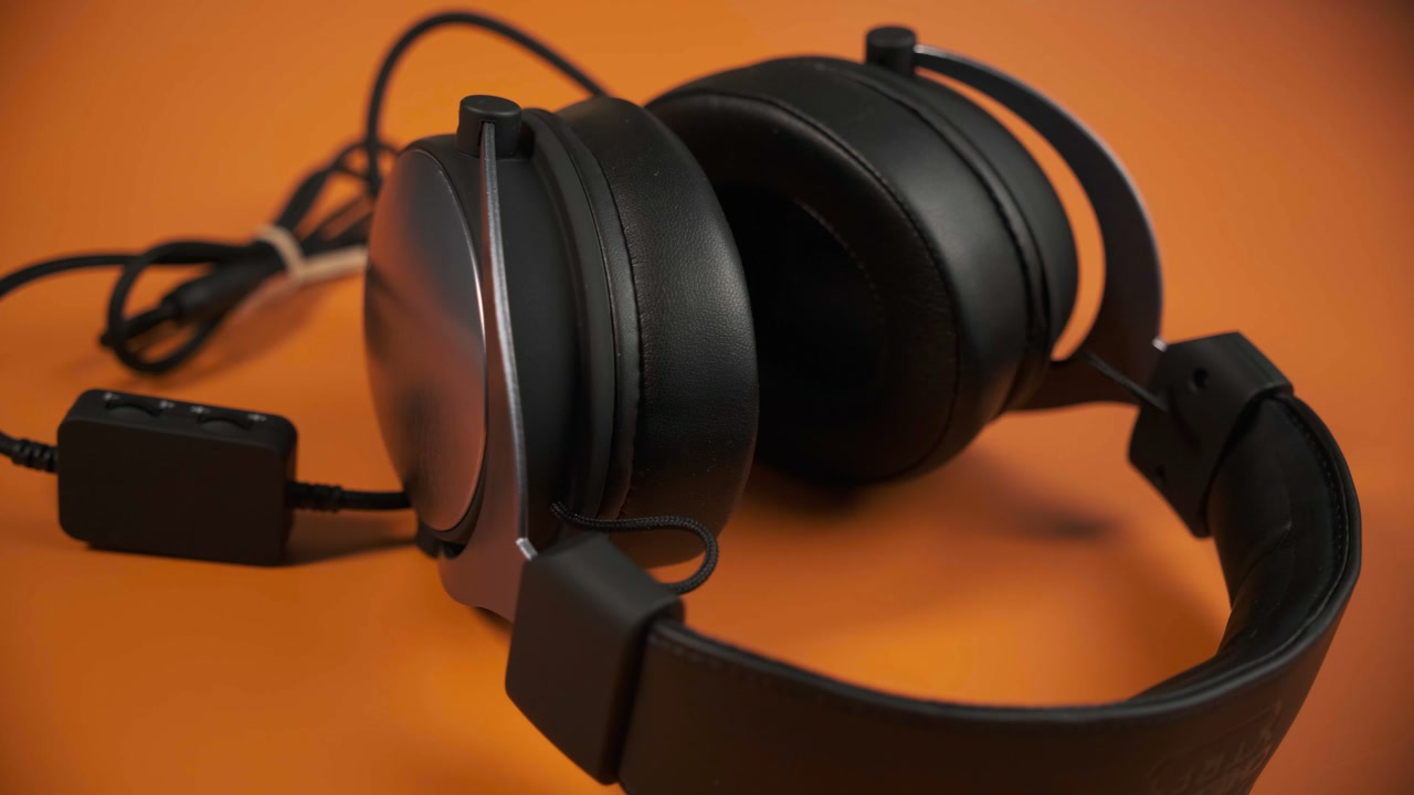 CHERRY XTRFY H1 gaming headset and microphone on an orange desk